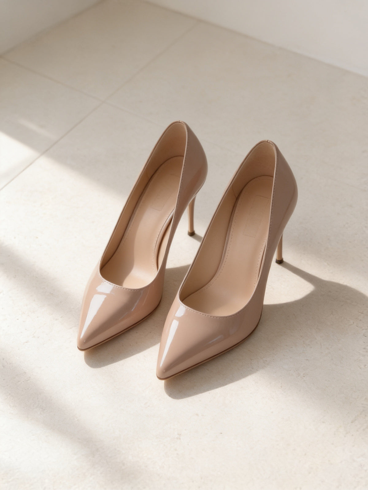 The Guest of Honour Pump in Nude, pair on pale limestone