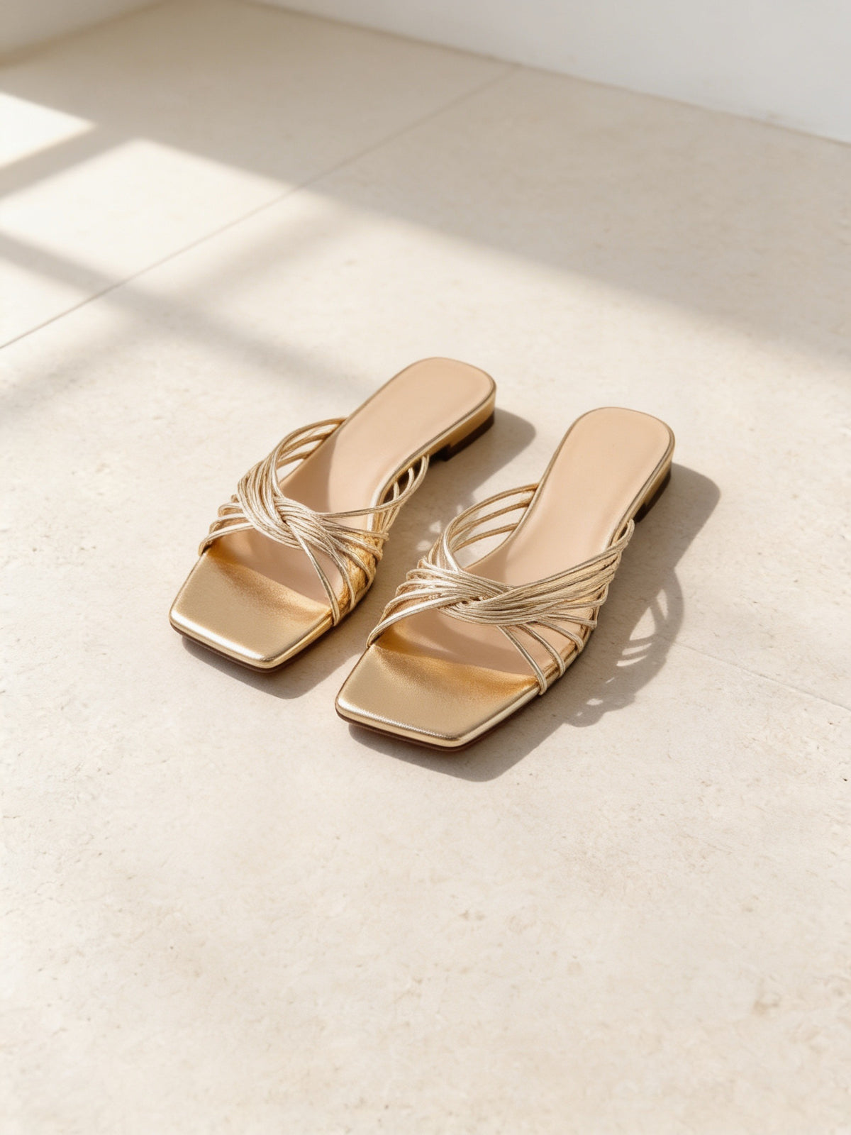 The Siesta Slide in Gold, pair on pale limestone