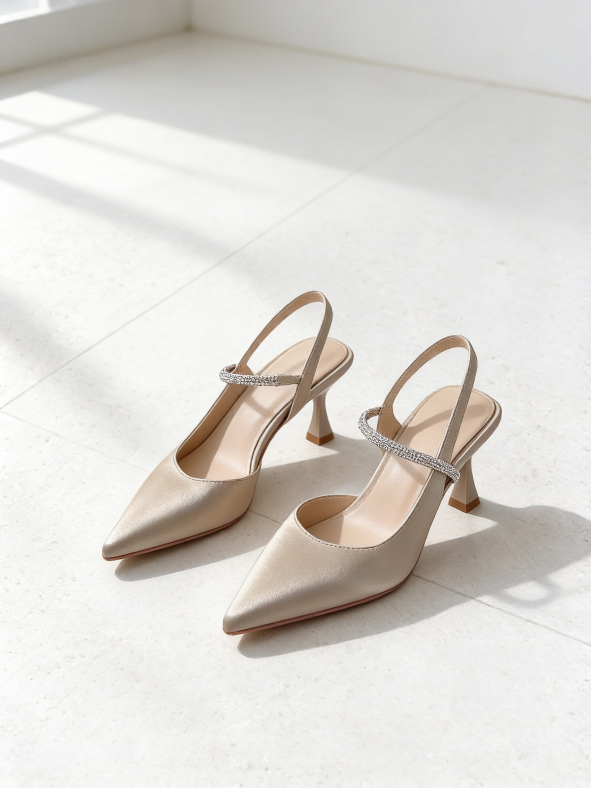 The Toast Slingback in Champagne, pair on pale limestone