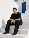 Marcel Afters Boxy Coolmax T-Shirt in Black, worn by a man, white stairs
