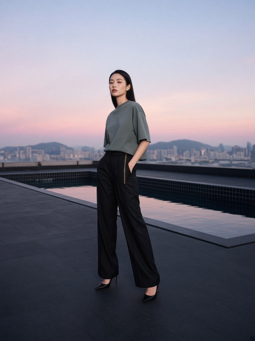 Marcel Afters Heavyweight Boxy Raw Edge T-Shirt in Gray Blue, worn by a woman, city rooftop at dusk