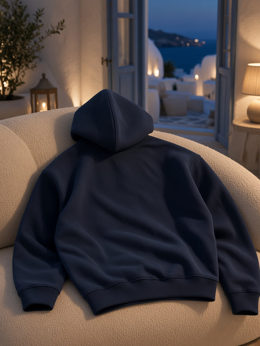 Marcel Afters Heavyweight Fleece Boxy Hoodie in Navy Blue, laid flat, living room