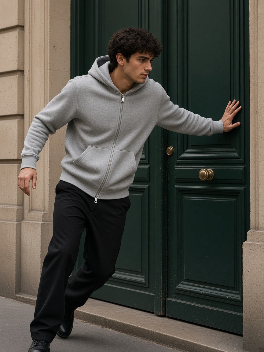 Marcel Afters Heavyweight Full Zip Hoodie in Flower Gray, worn by a man, leaning on a green door in Paris