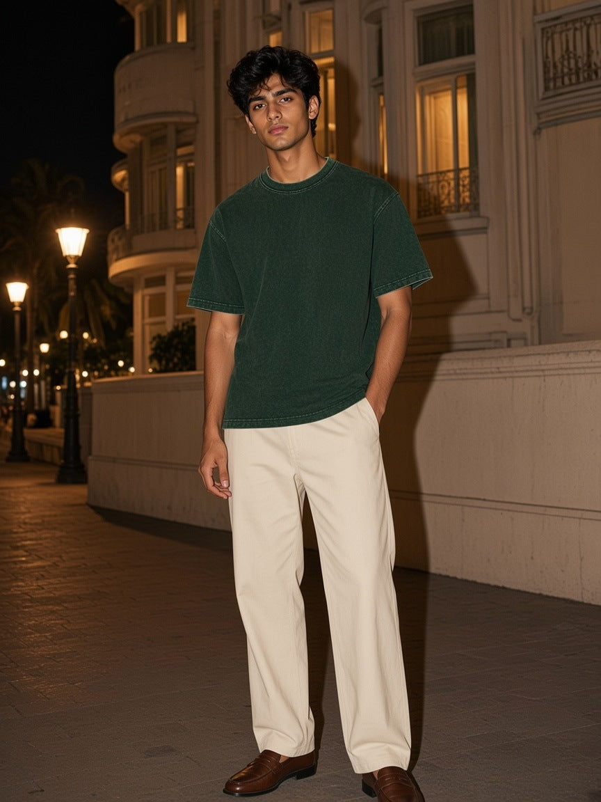 Marcel Afters Heavyweight Mineral Wash Boxy T-Shirt in Dark Green, worn by a man, city street at night