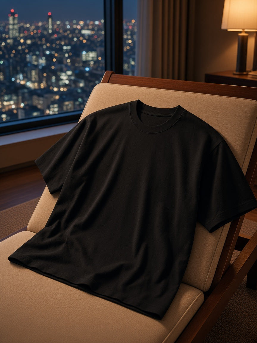 Marcel Afters Heavyweight Oversized T-Shirt in Black, laid flat, hotel room