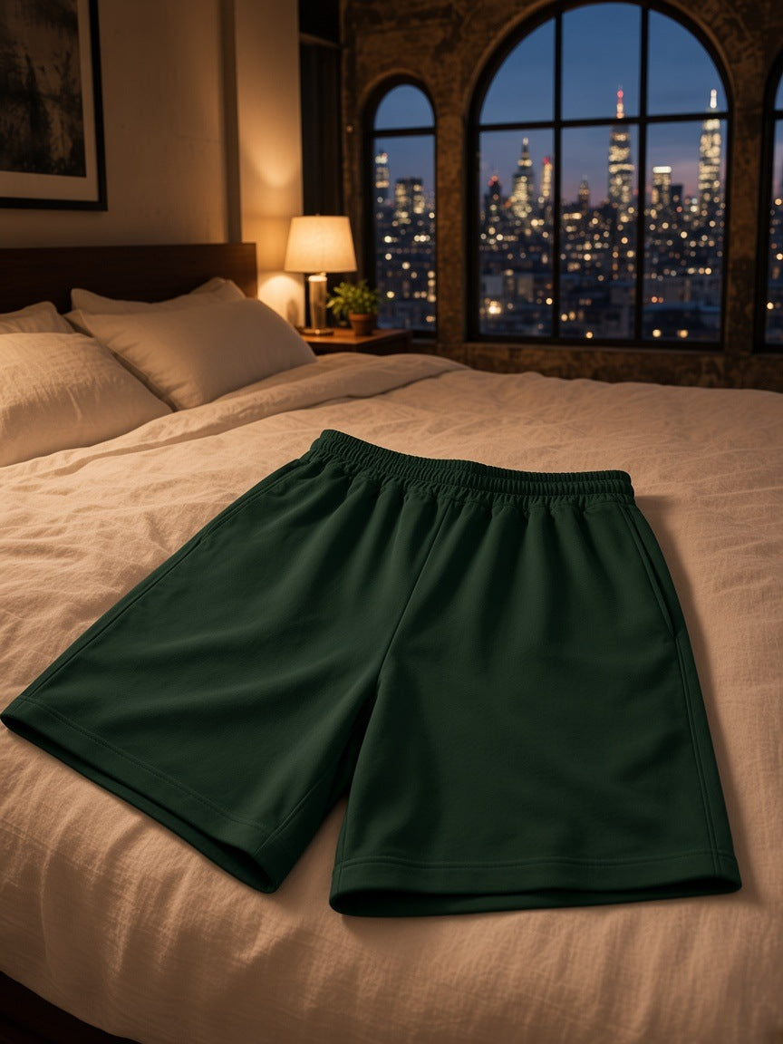 Marcel Afters Heavyweight Shorts in Blackish Green, laid flat, bedroom
