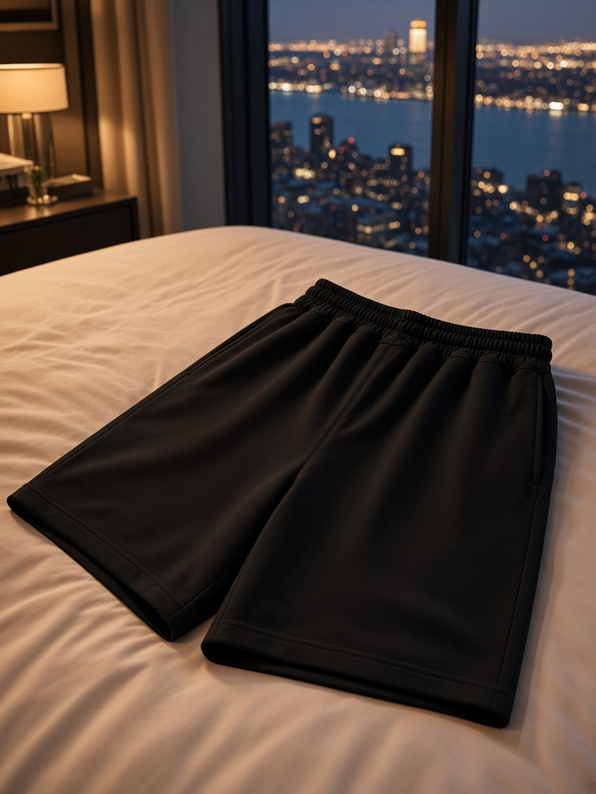 Marcel Afters Heavyweight Shorts in Black, laid flat, hotel room