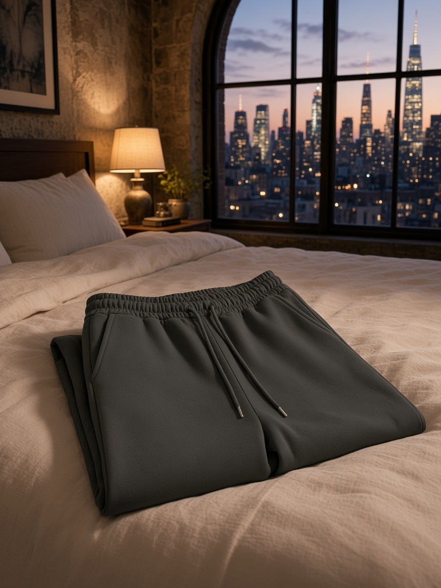 Marcel Afters Heavyweight Sweatpants in Black, laid flat, bedroom