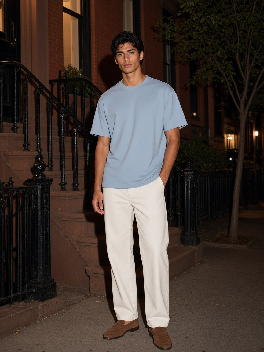 Marcel Afters Lightweight Oversized T-Shirt in Haze Blue, worn by a woman, against a plain white background