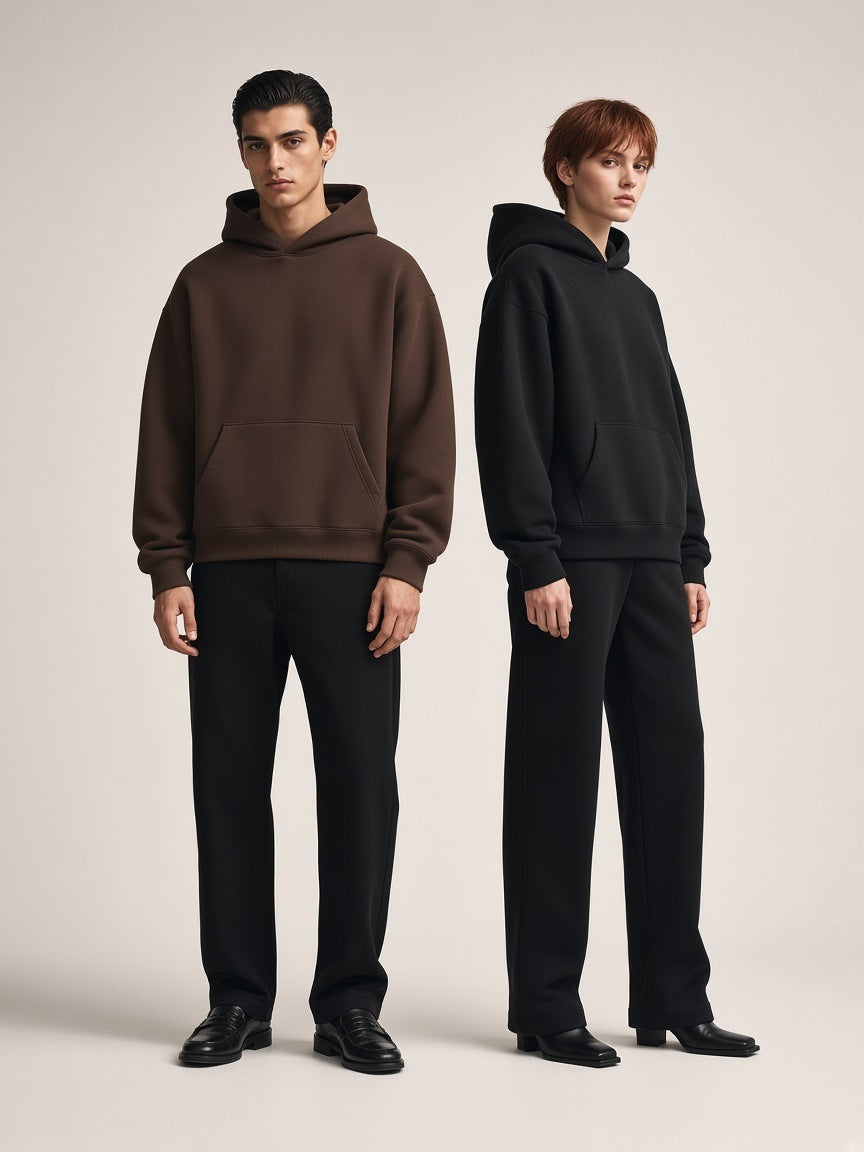 Marcel Afters Oversized Heavyweight Hoodie in Coffee, worn by a man and a woman, posed in a bright studio, he in coffee and she in black