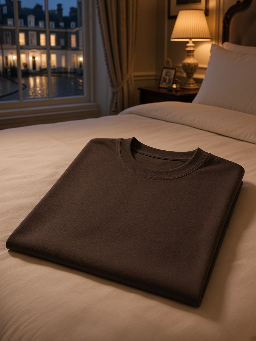 Marcel Afters Oversized T-Shirt in Black, laid flat, bedroom