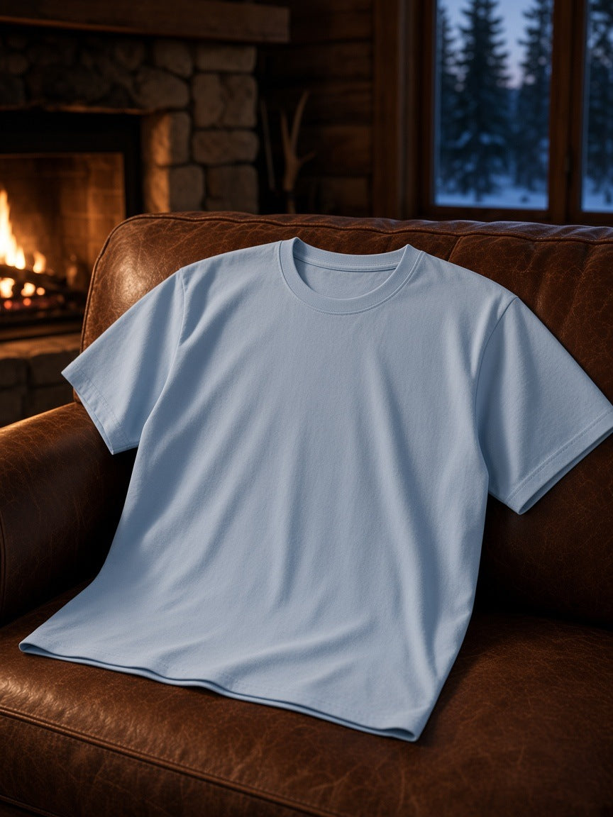 Marcel Afters Regular Fit Coolmax T-Shirt in Sky Blue, laid flat, leather sofa