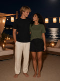 Marcel Afters Seamless Cotton T-Shirt in Black, worn by a man, beach