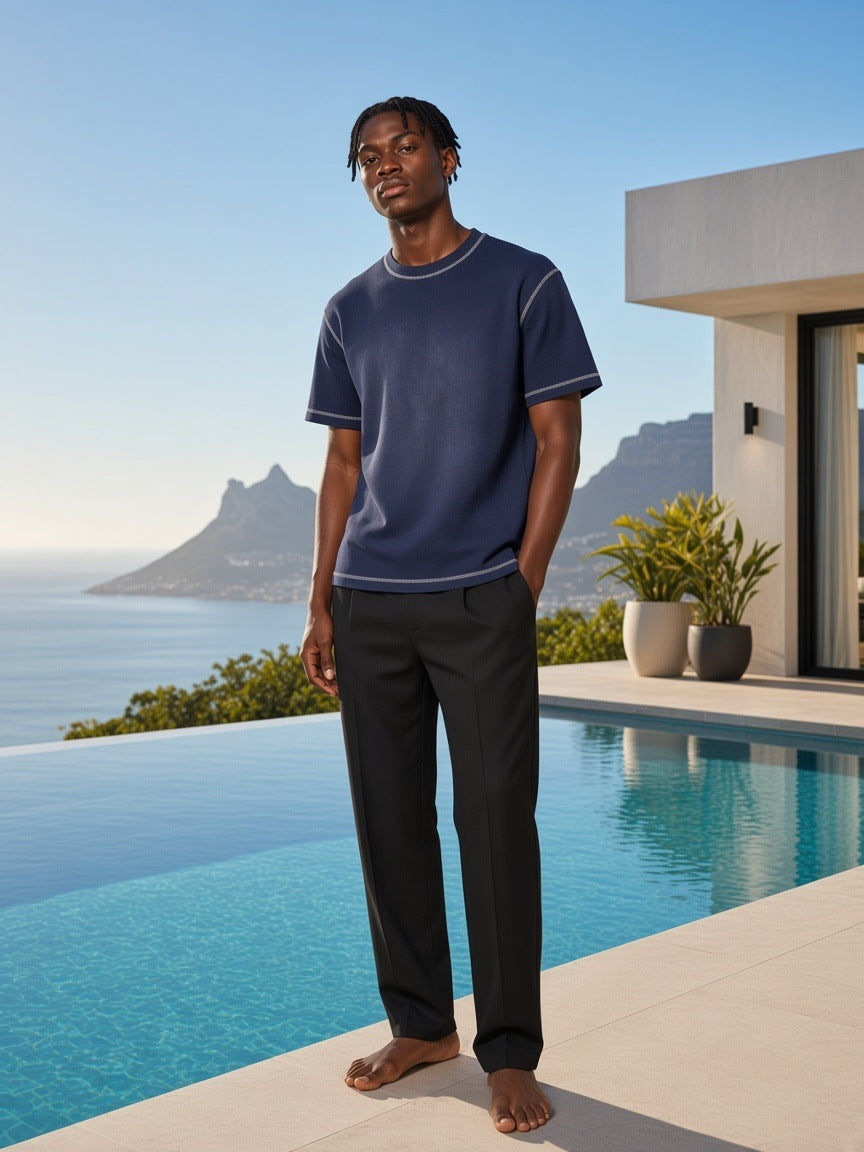 Marcel Afters Sunfade Waffle Boxy T-Shirt in Navy Blue, worn by a man, by the pool
