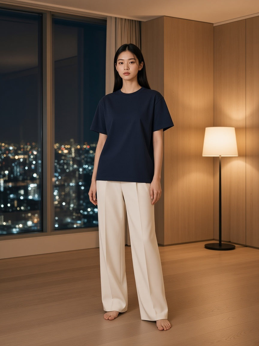 Marcel Afters Vintage Wash Distressed T-Shirt in Navy Blue, worn by a woman, city at night