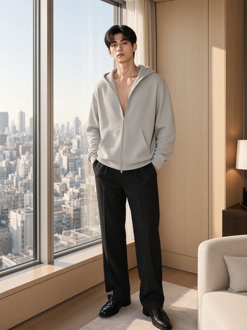 Marcel Afters Waffle Boxy Full Zip Hoodie in Flower Gray, worn by a man, standing by a floor-to-ceiling window above the city