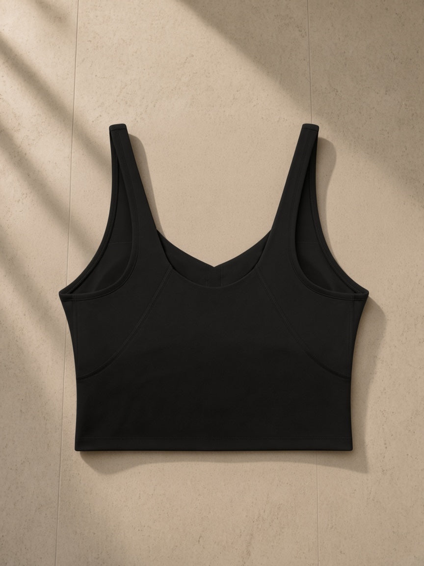 Women's V-Neck Yoga Sports Bra in Black, laid flat on pale limestone, front view