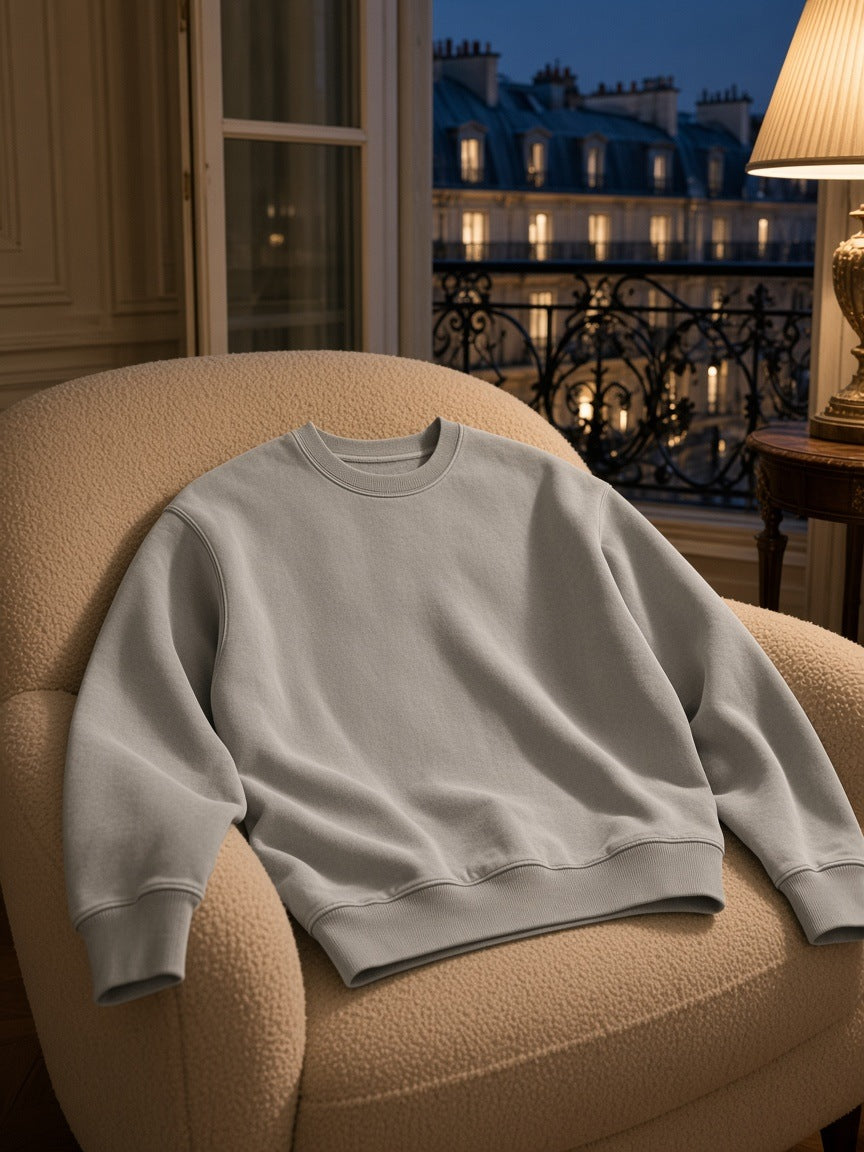 Marcel Afters Vintage Wash Crewneck Sweatshirt in Light Gray, laid flat, city at dusk