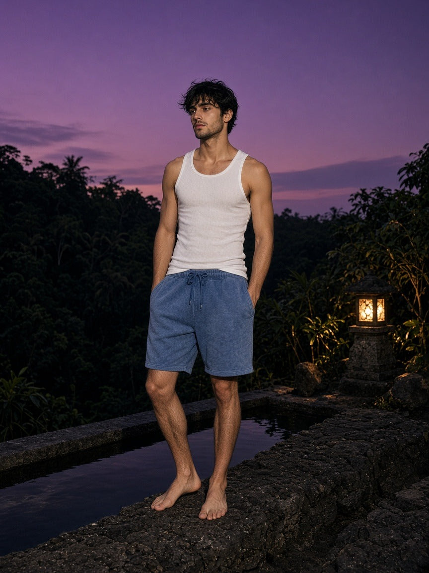 Marcel Afters Vintage Wash Fleece Shorts in Washed Blue, worn by a man, outdoors