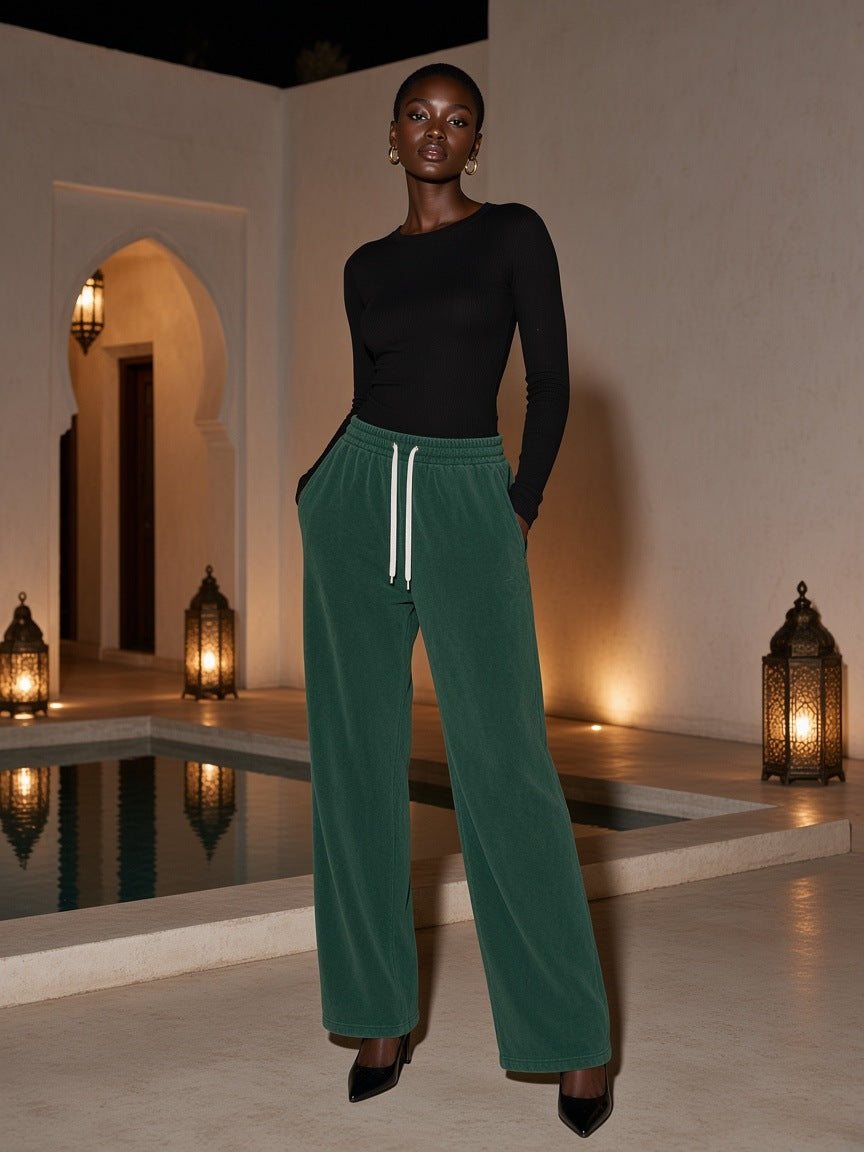 Marcel Afters Vintage Wash Fleece Sweatpants in Dark Green, worn by a woman, against a plain white background