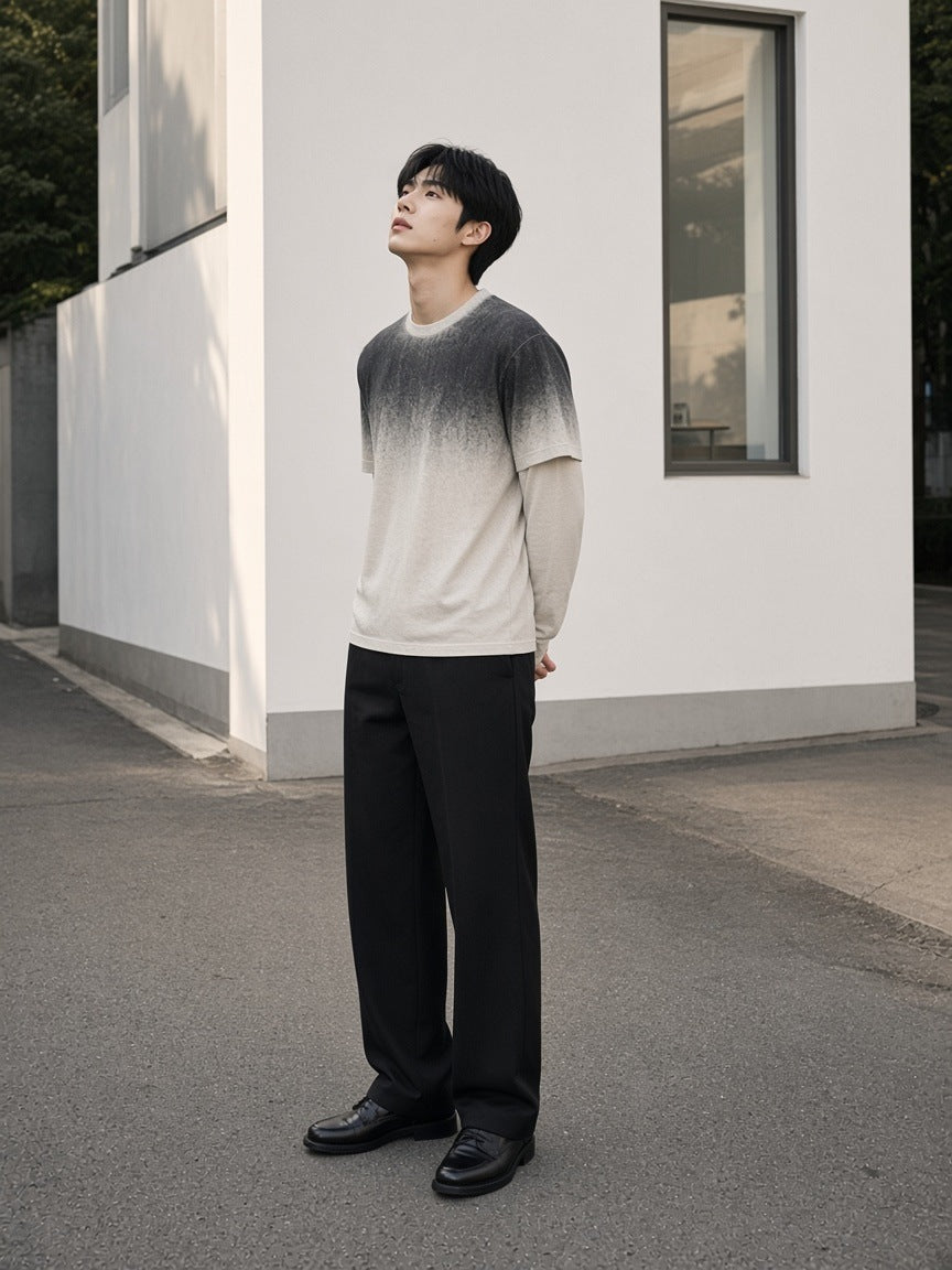 Marcel Afters Vintage Wash Layered T-Shirt in White Gray, worn by a man, looking up beside a white wall in a gradient layered tee