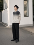 Marcel Afters Vintage Wash Layered T-Shirt in White Gray, worn by a man, looking up beside a white wall in a gradient layered tee