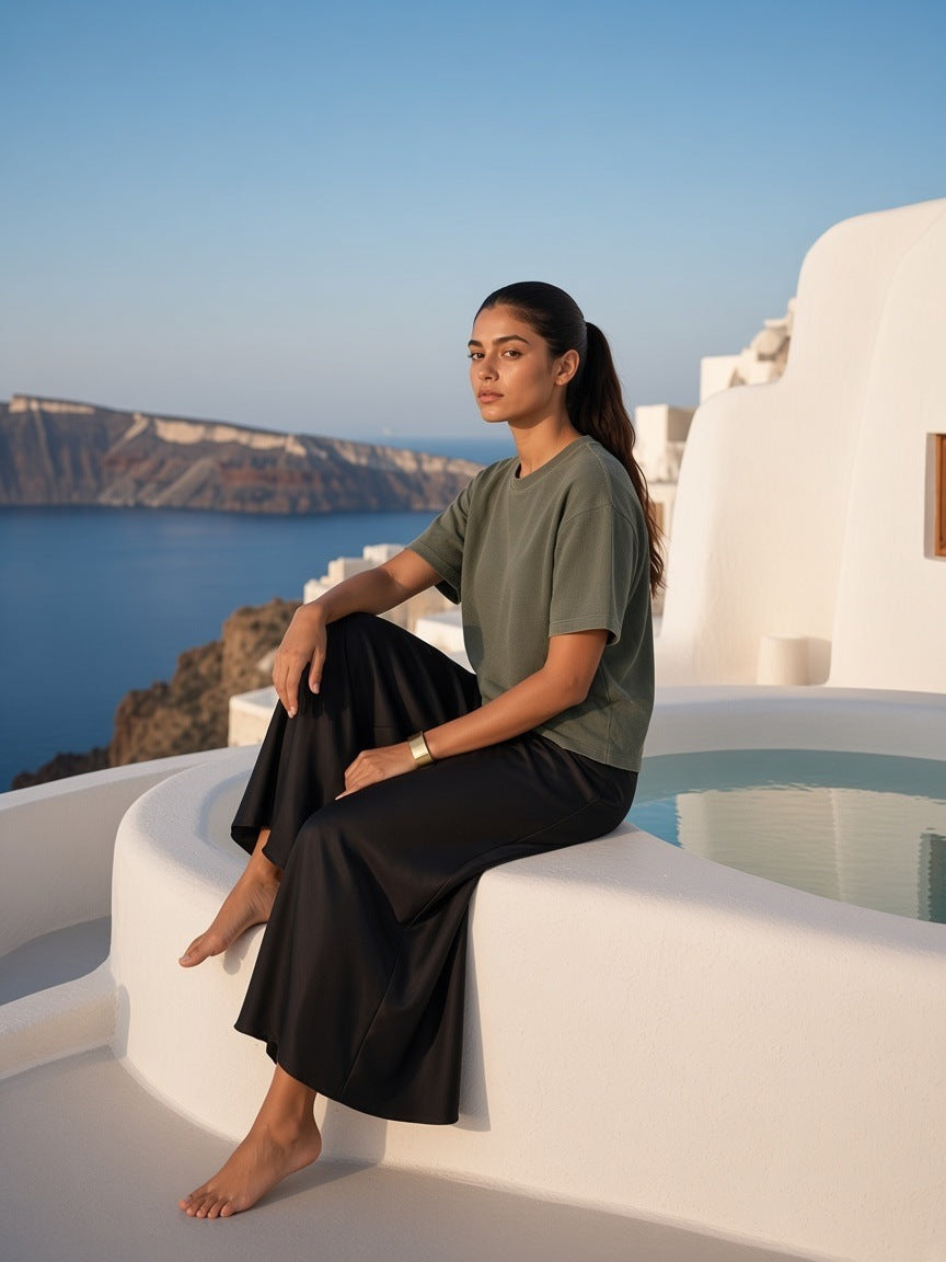 Woman in the Vintage Wash Sunfade Boxy Waffle T-Shirt in Army Green at a cave-villa pool in Santorini in the morning