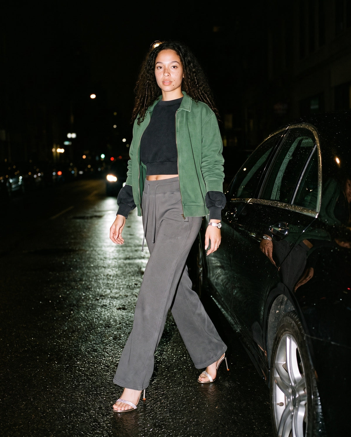 Man wearing the Marcel Afters Vintage Washed Flared Fleece Pants — Dark in Dark Gray, full-length editorial photograph