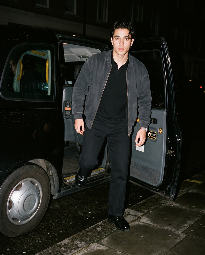 Man wearing the Vintage Washed Fleece Baseball Jacket in Black, full-length model photo