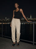 Woman wearing the Vintage Washed Fleece Jogger Sweatpants in Apricot, full-length model photo