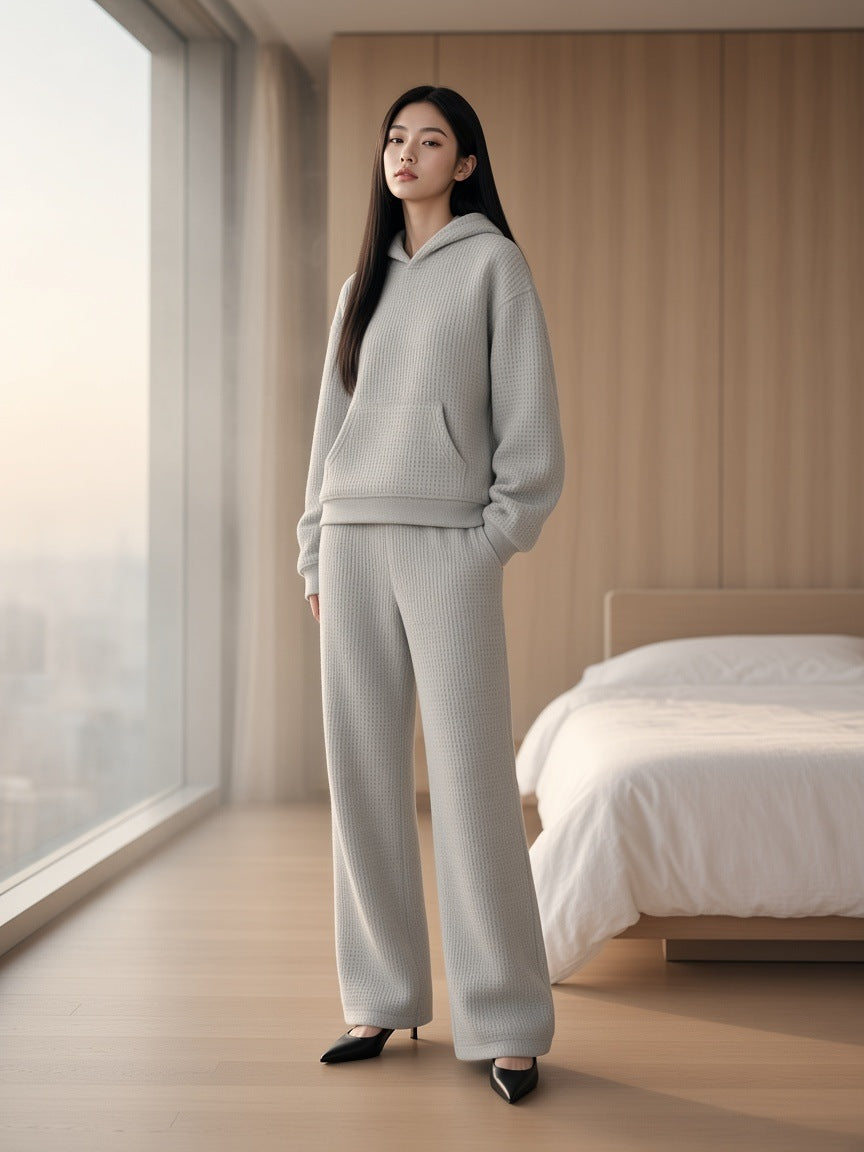 Marcel Afters Waffle Boxy Hoodie in Oat Gray, worn by a woman, bedroom