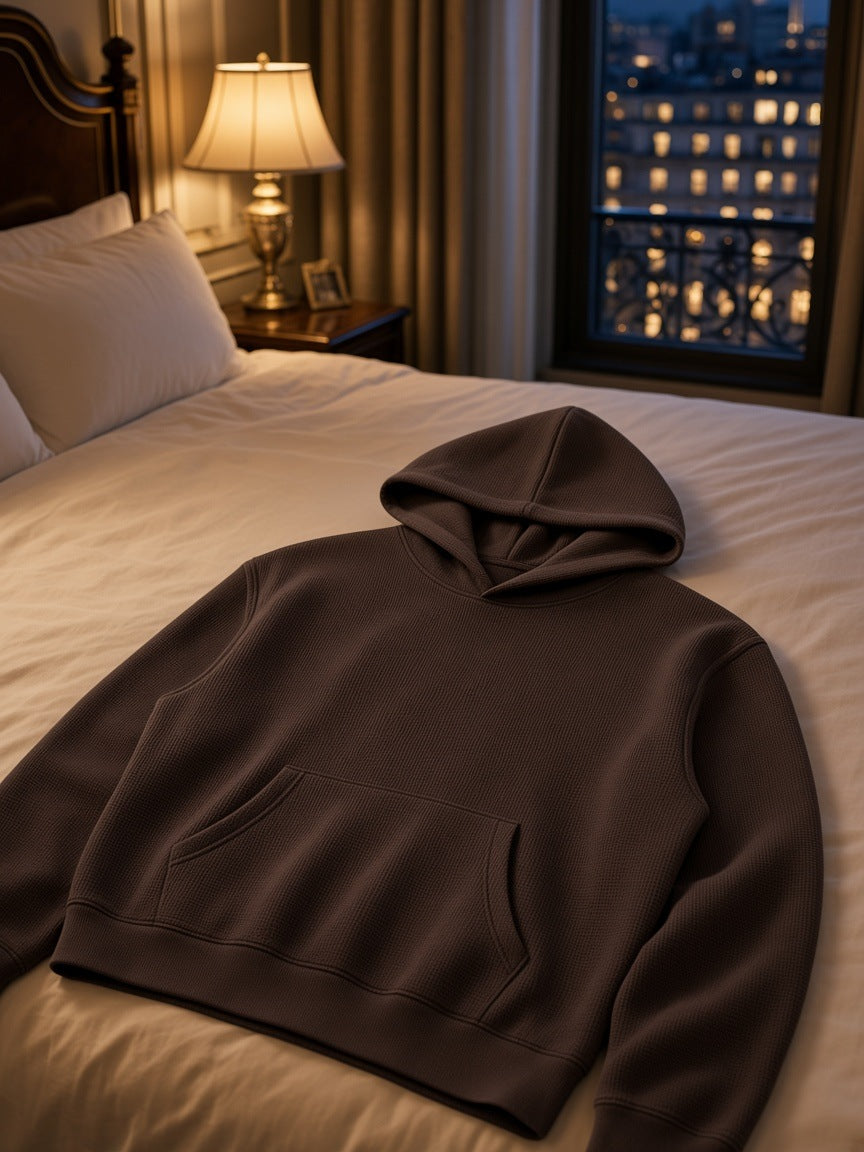 Marcel Afters Waffle Boxy Hoodie in Dark Gray, laid flat, hotel room