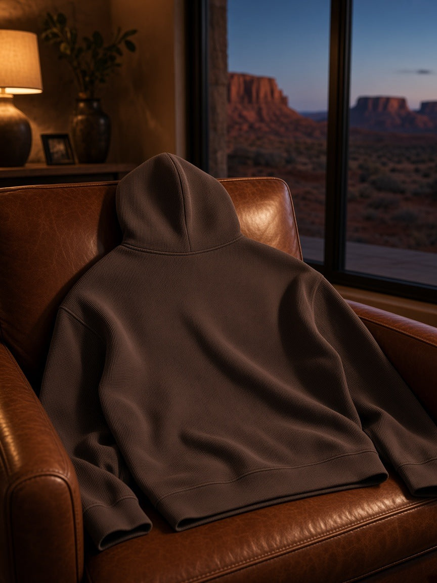 Marcel Afters Waffle Hoodie in Dark Gray, laid flat, living room
