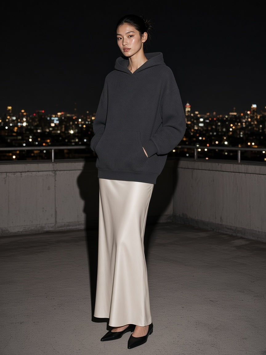 Marcel Afters Waffle Hoodie in Black, worn by a woman, city rooftop at night
