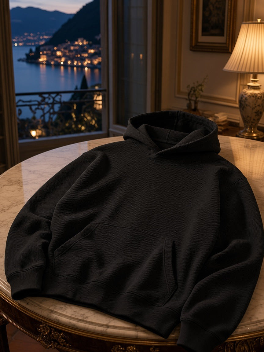 Marcel Afters Waffle Hoodie in Black, worn by a woman, in a room