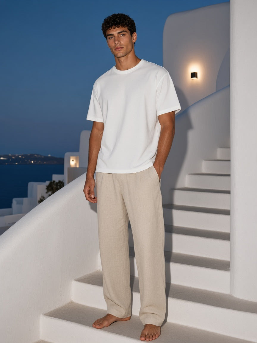 Marcel Afters Washed Rolled Hem Half Sleeve T-Shirt in White, worn by a man, white stairs