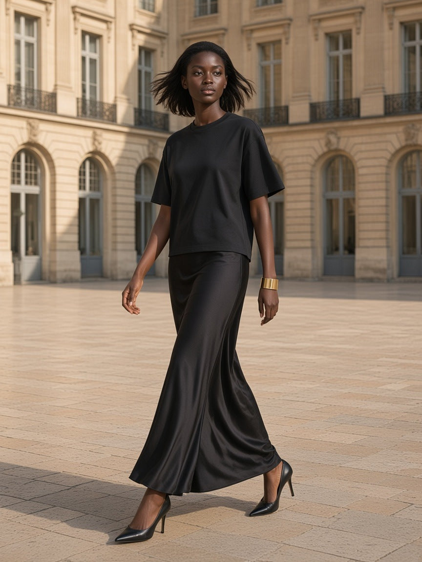 Woman in the Washed Rolled Hem Half Sleeve T-Shirt in Black, in a grand hotel's limestone courtyard in the morning in Paris