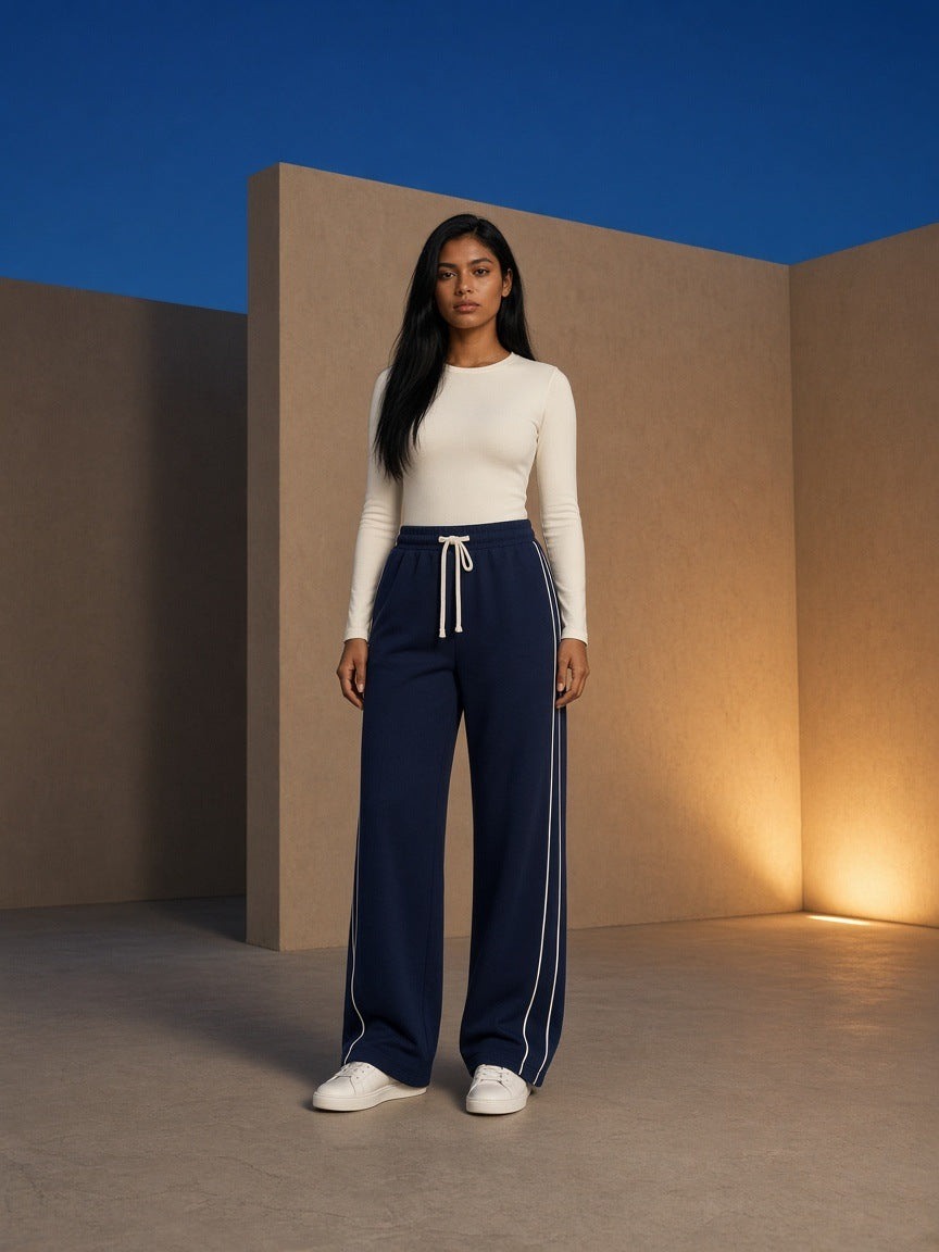 Marcel Afters Wide Leg Piping Sweatpants in Navy Blue, worn by a woman, studio