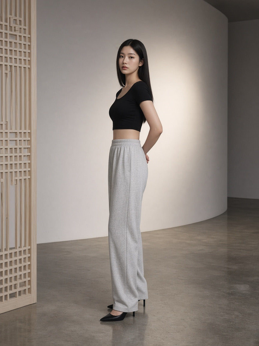 Woman wearing the Women's Solid Color Slim Crop T-Shirt in Black, full-length model photo