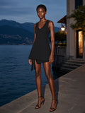 Woman in the A-Line Sleeveless Dress in Black standing on a villa dock on Lake Como at night