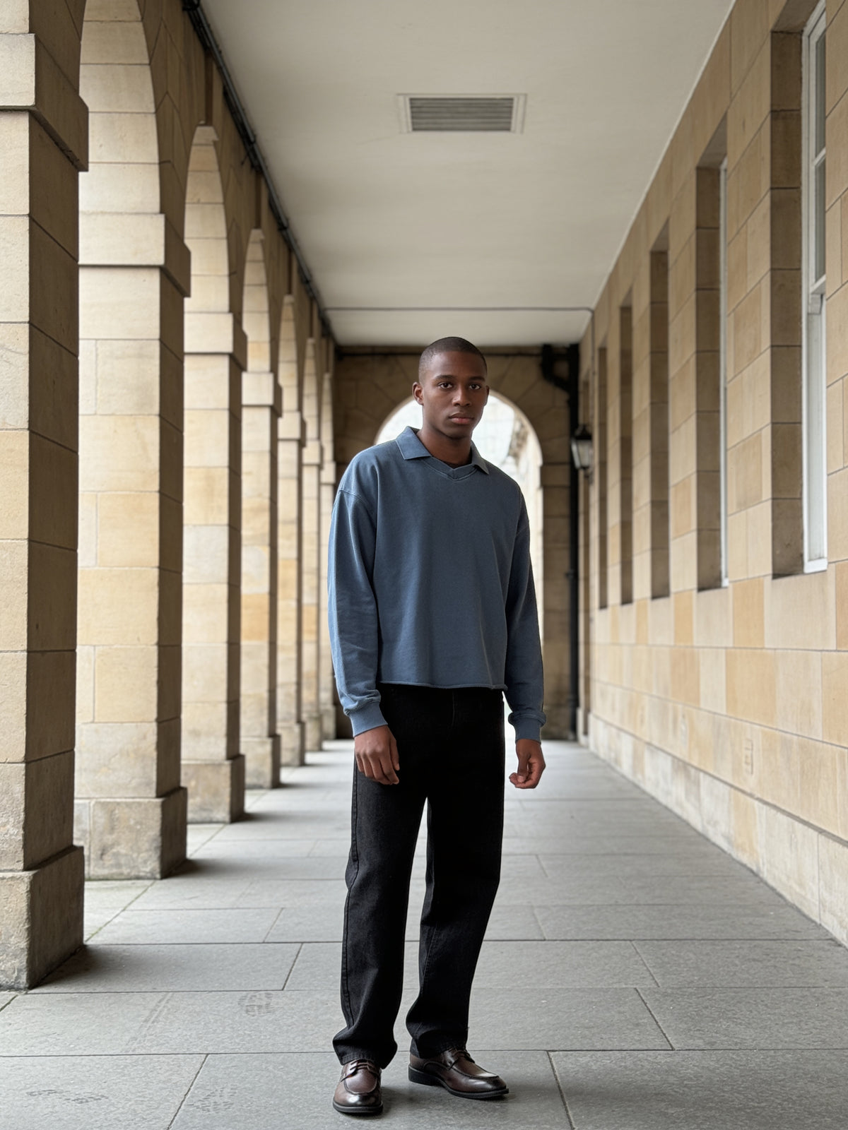 The Wine List Derby worn on model in a sandstone arcade in Edinburgh