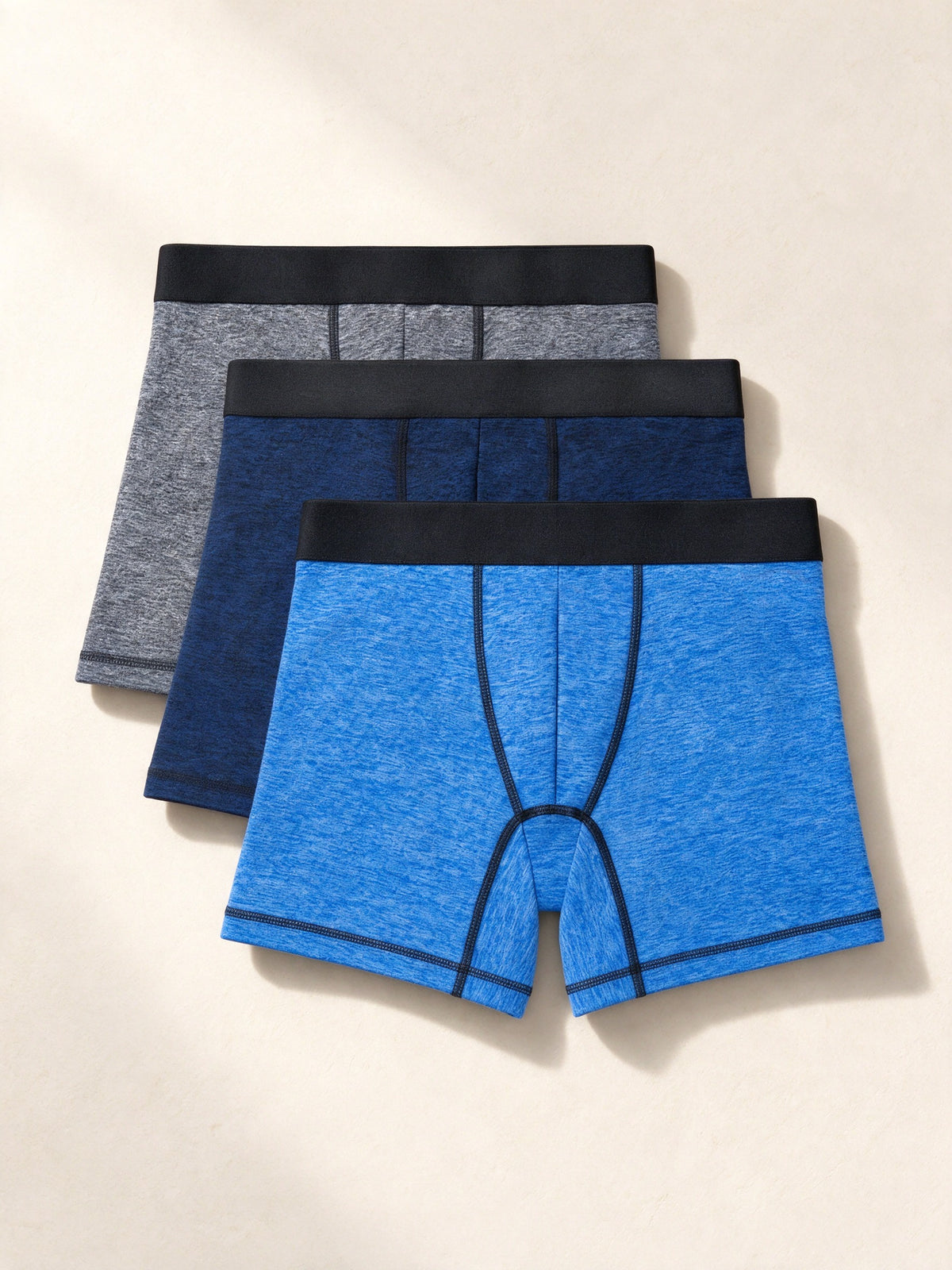 True Notions Boxer Briefs 3-Pack - Blue / Black, laid flat on limestone