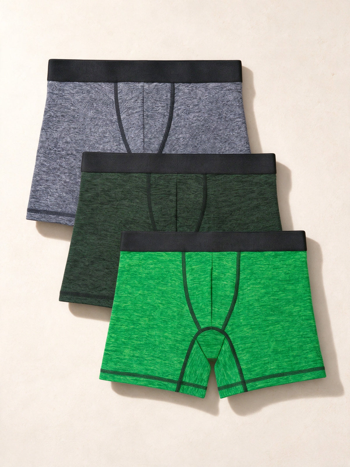 True Notions Boxer Briefs 3-Pack - Green / Black, laid flat on limestone