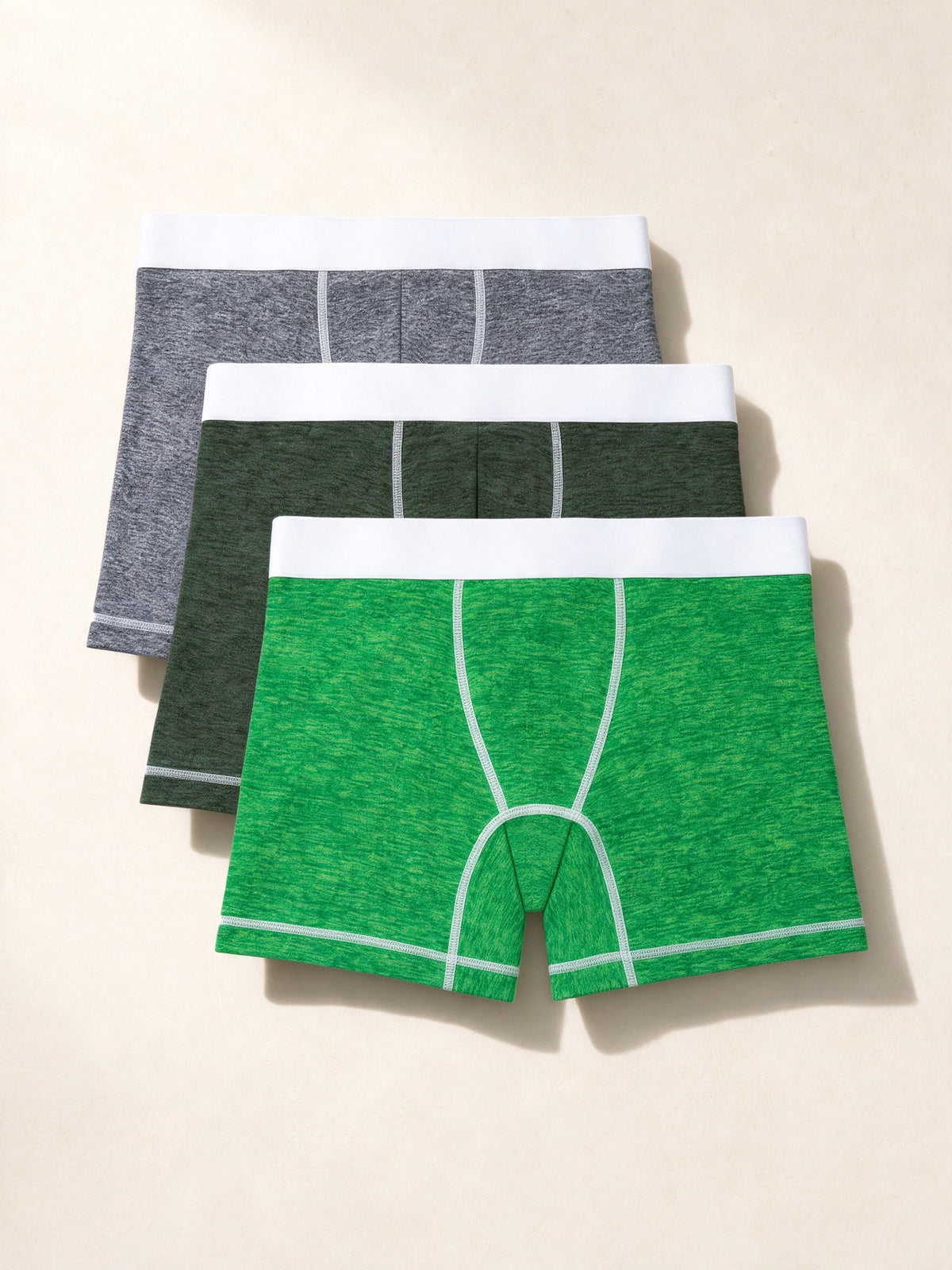 True Notions Boxer Briefs 3-Pack - Green / White, laid flat on limestone