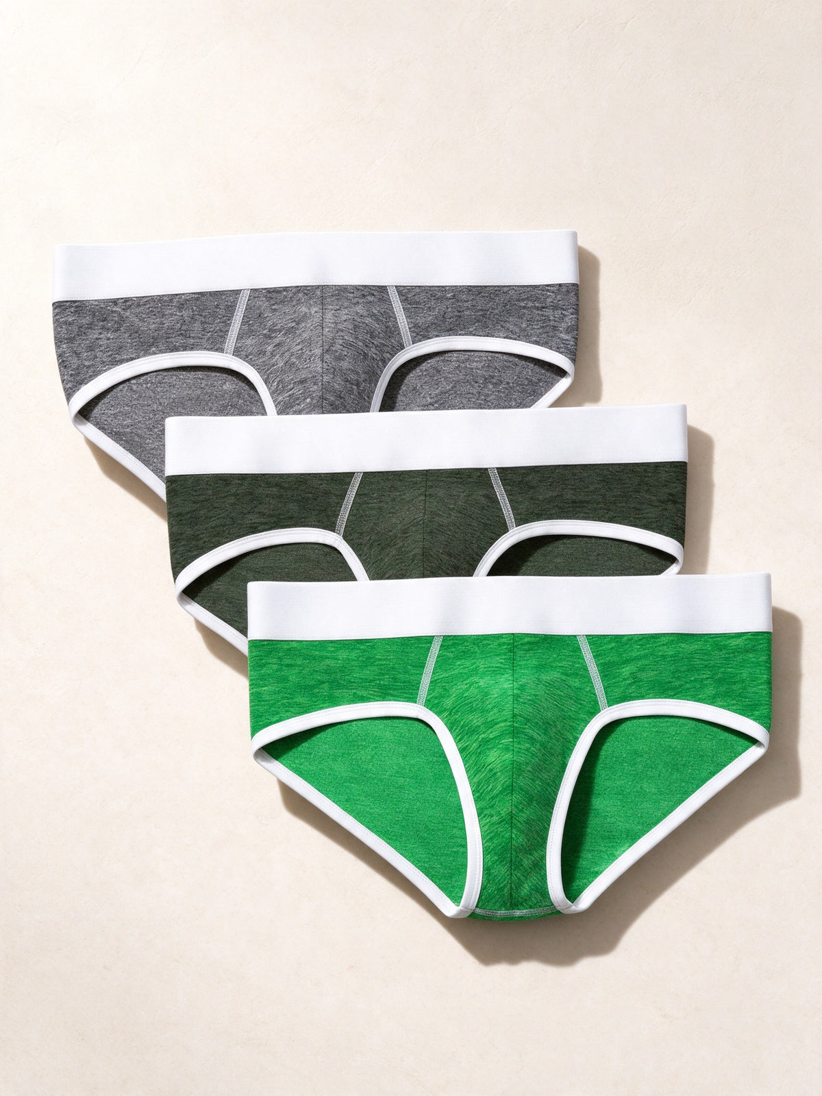 True Notions Briefs 3-Pack - Green / White, laid flat on limestone