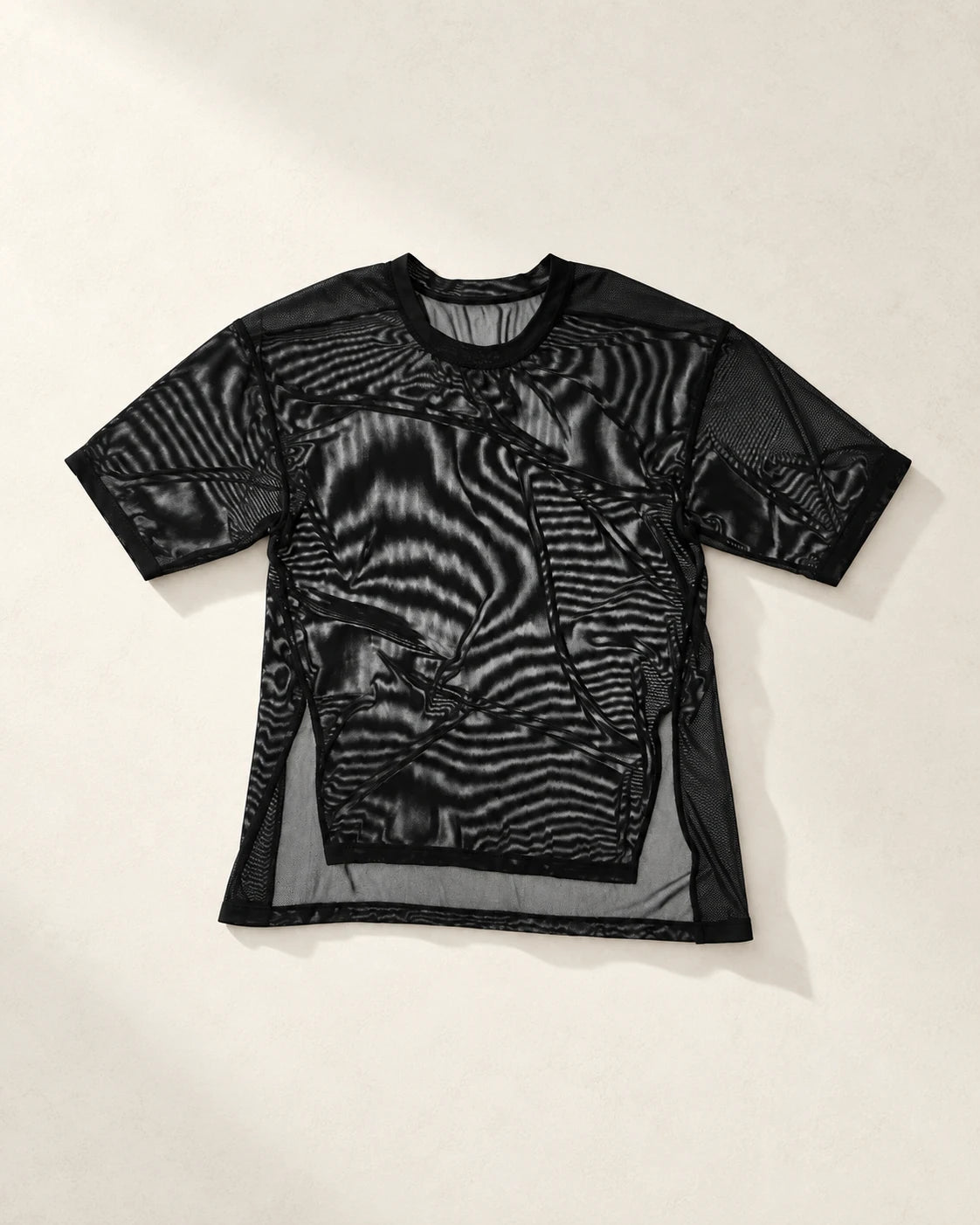 True Notions Flex Mesh Oversized Tee - Black, laid flat on limestone