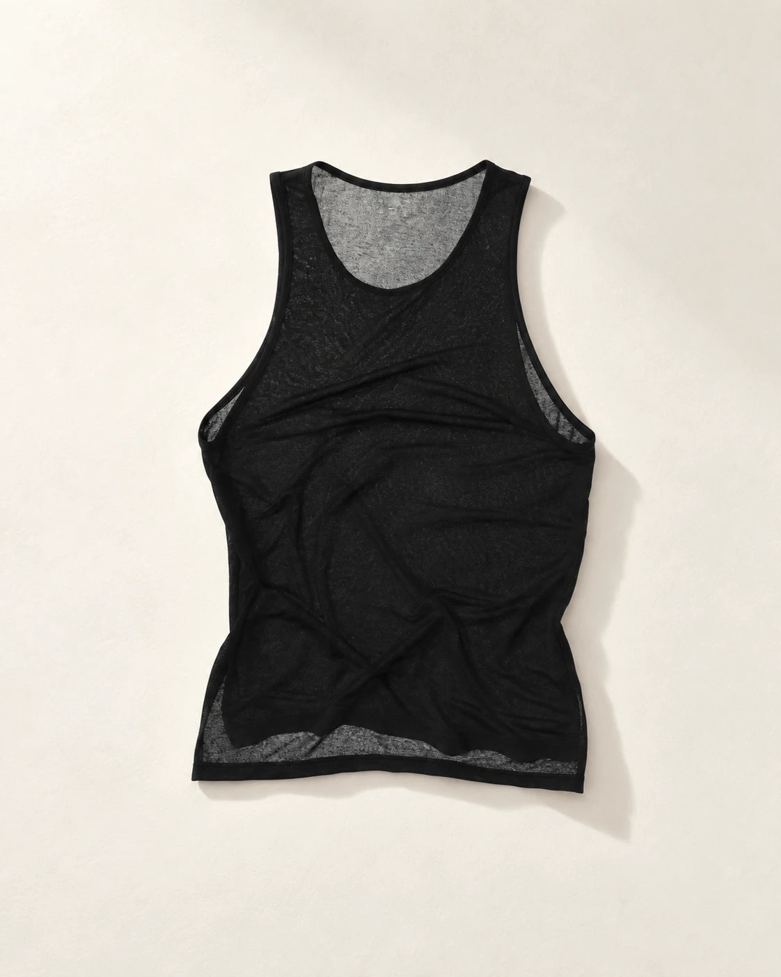 True Notions Flex Sylk Tank Top - Black, laid flat on limestone