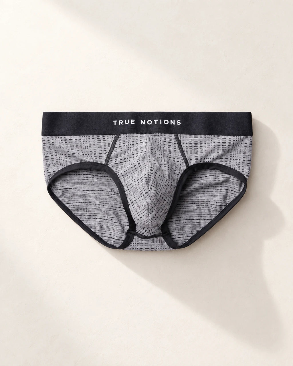 True Notions Tartan Brief - Grey, laid flat on limestone