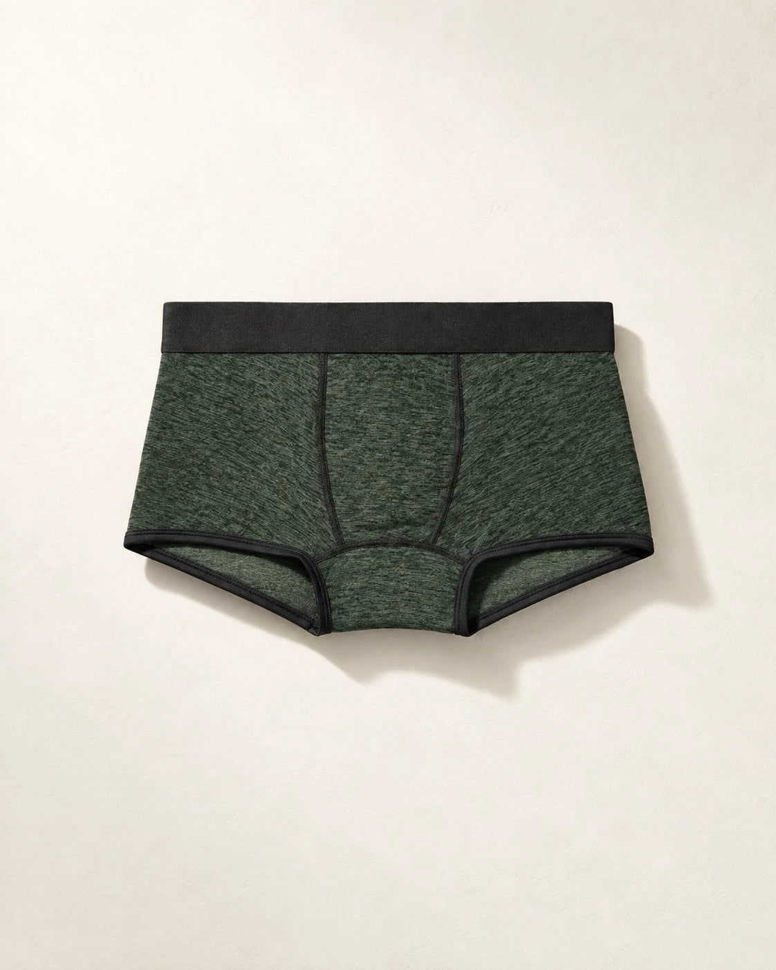 True Notions Trunk - Olive / Black, laid flat on limestone
