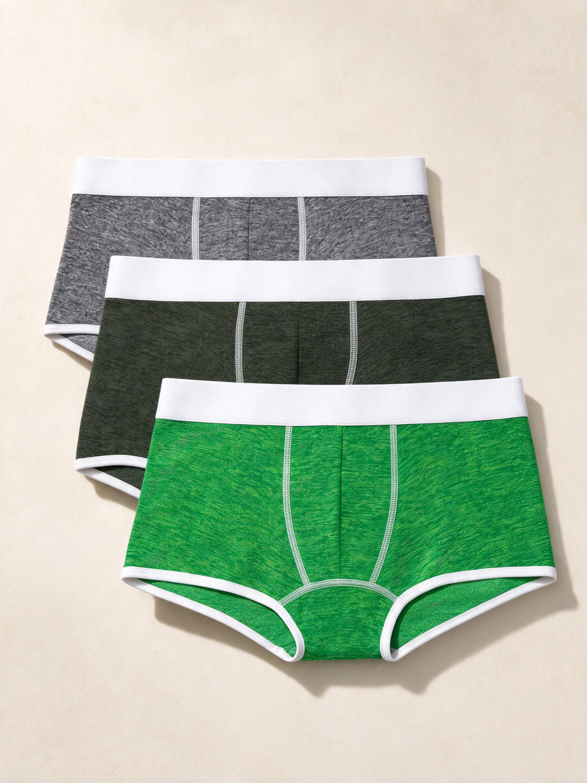 True Notions Trunks 3-Pack - Green / White, laid flat on limestone